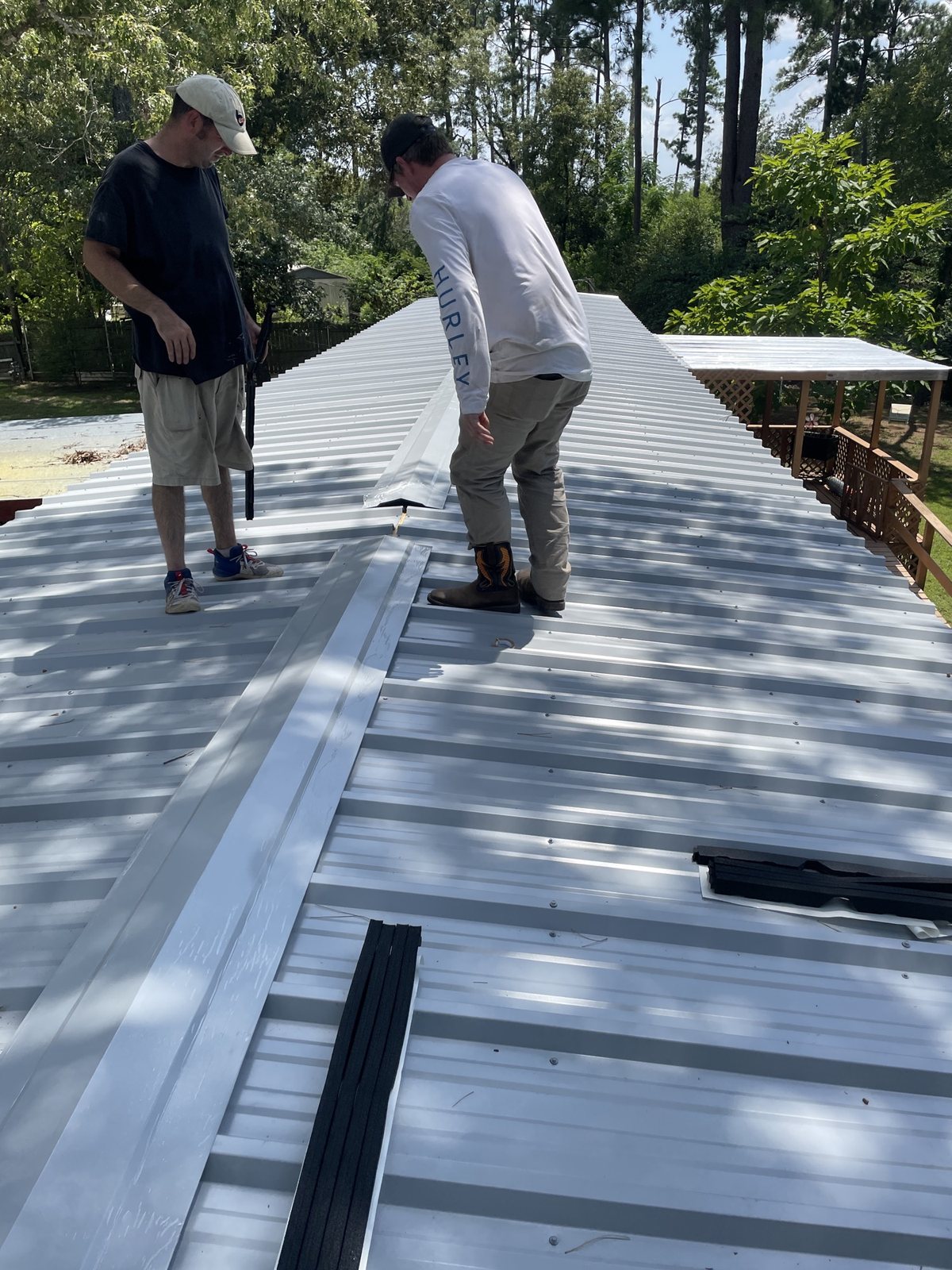 Installing standing seam panels and ridge cap